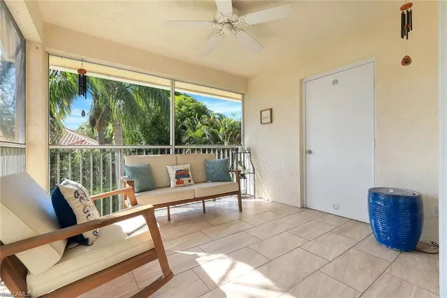 a balcony with furniture and a potted plant