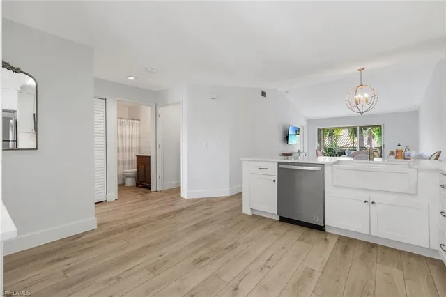 a kitchen with stainless steel appliances a stove top oven a sink dishwasher and a refrigerator