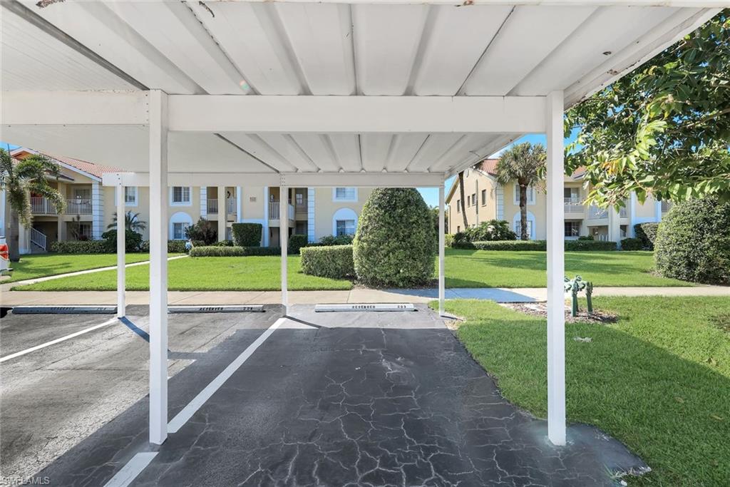 7767 Jewel Lane, Unit 203 Naples, FL 34109 - Photo 24 of 29 a view of a house with a backyard