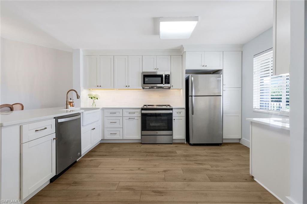 7767 Jewel Lane, Unit 203 Naples, FL 34109 - Photo 2 of 29 a kitchen with a refrigerator stove and sink
