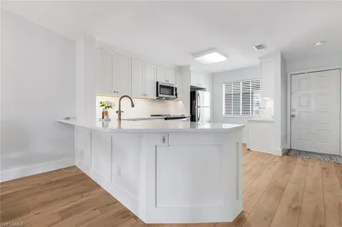 a kitchen with a refrigerator stove and sink