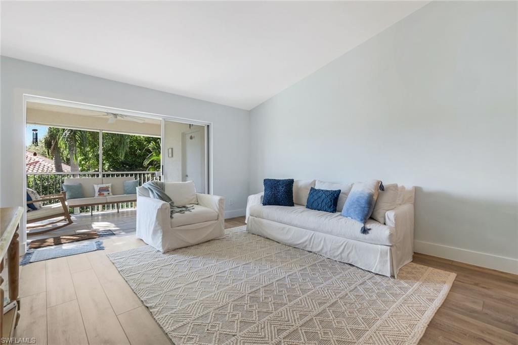 7767 Jewel Lane, Unit 203 Naples, FL 34109 - Photo 7 of 29 a living room with furniture and a large window
