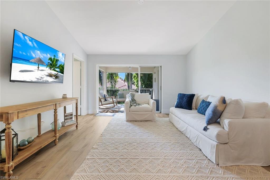 7767 Jewel Lane, Unit 203 Naples, FL 34109 - Photo 8 of 29 a living room with furniture and a flat screen tv