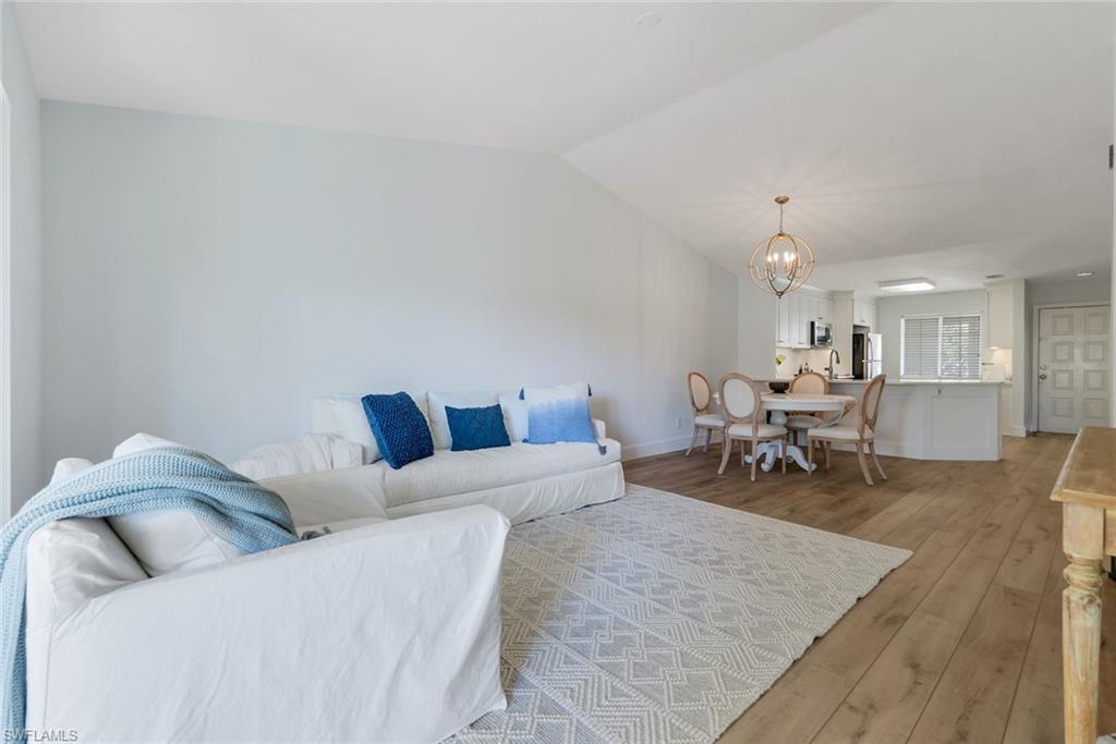 7767 Jewel Lane, Unit 203 Naples, FL 34109 - Photo 9 of 29 a living room with furniture and kitchen view