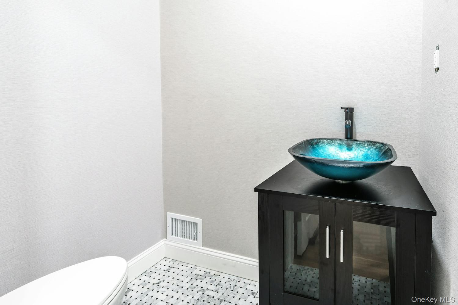 539 Split Rock Road Syosset, NY 11791 - Photo 16 of 40 Half bath featuring toilet, baseboards, visible vents, and a sink