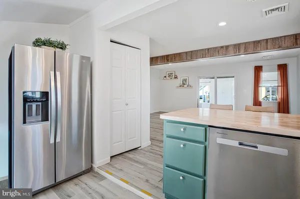 a kitchen with cabinets and stainless steel appliances