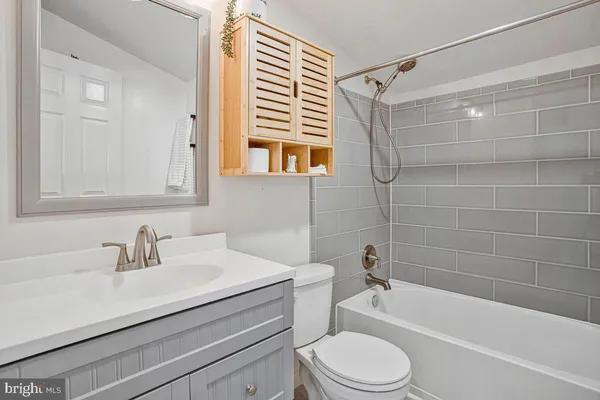 a bathroom with a sink a toilet and a bathtub