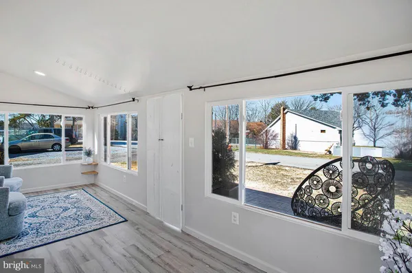 a view of a bedroom with furniture and windows