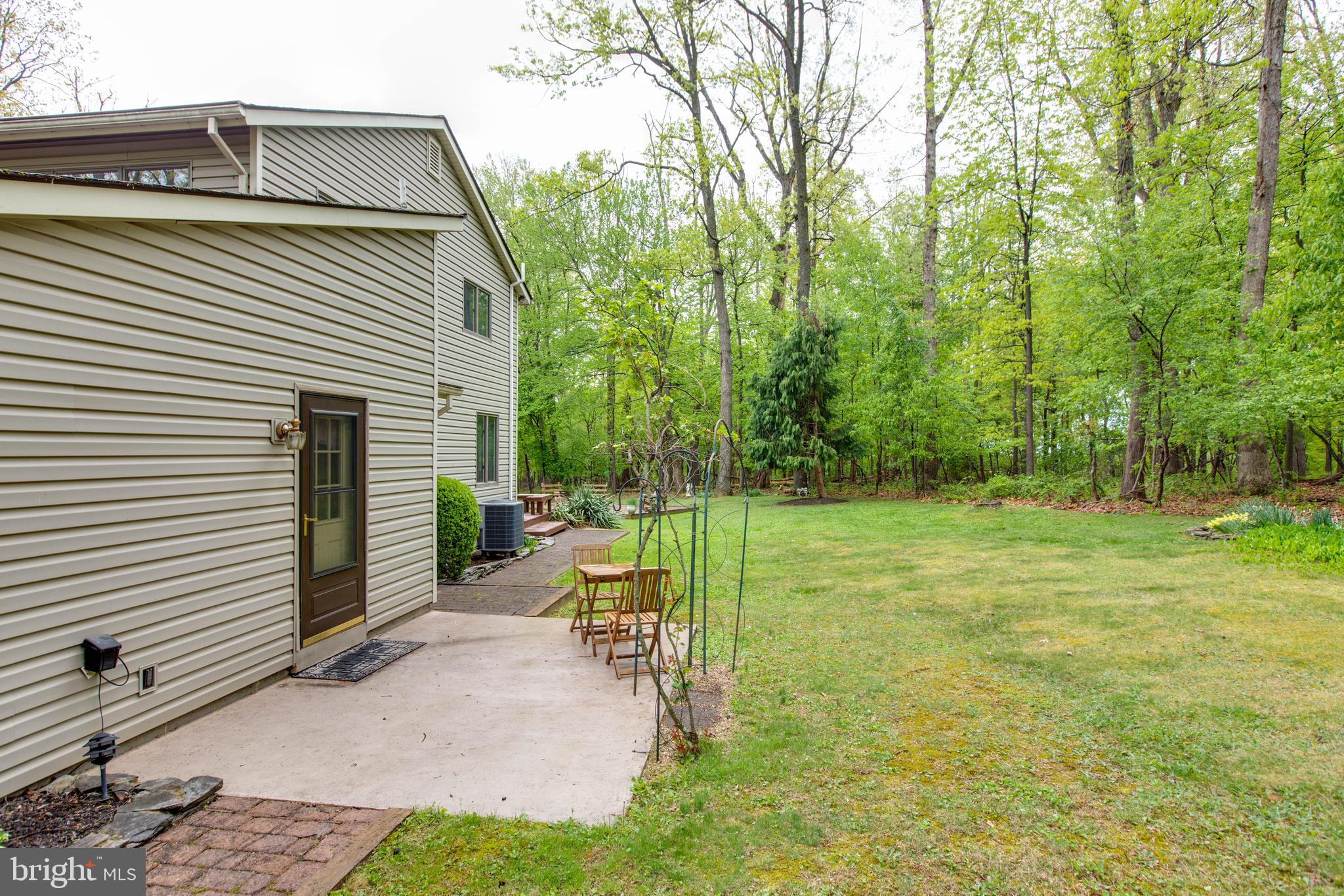 5519 Woodbine Road Sykesville, MD 21784 - Photo 8 of 69 a view of a patio with a table and chairs next to a yard