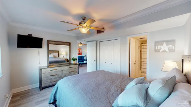 a bedroom with a bed and a television