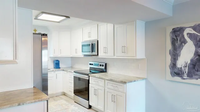 a kitchen with stainless steel appliances granite countertop a sink and a stove top oven
