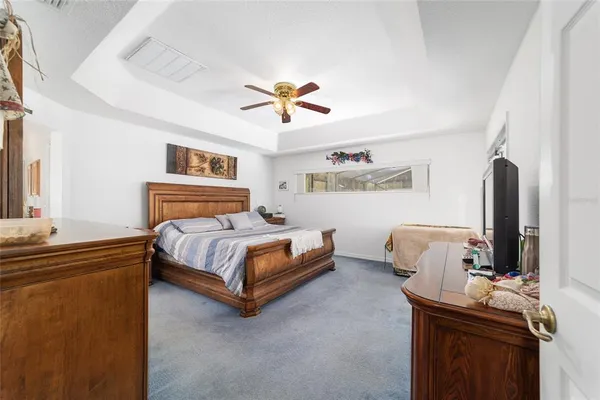 a bedroom with furniture and a flat screen tv