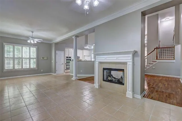 a kitchen with granite countertop white cabinets and refrigerator