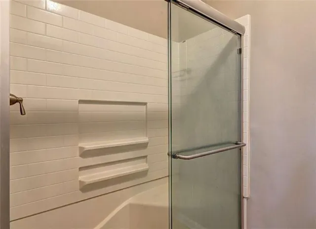 a view of an empty room with a chandelier fan