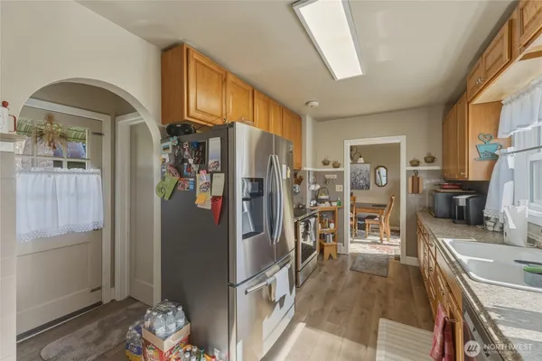 a kitchen with stainless steel appliances granite countertop a refrigerator and a sink