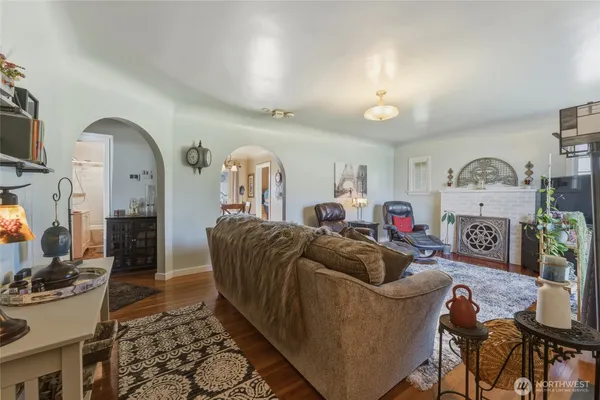 a living room with furniture a rug and a fireplace