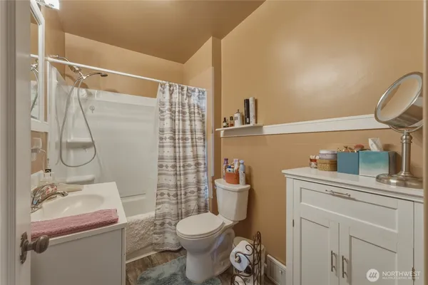 a bathroom with a sink toilet and shower