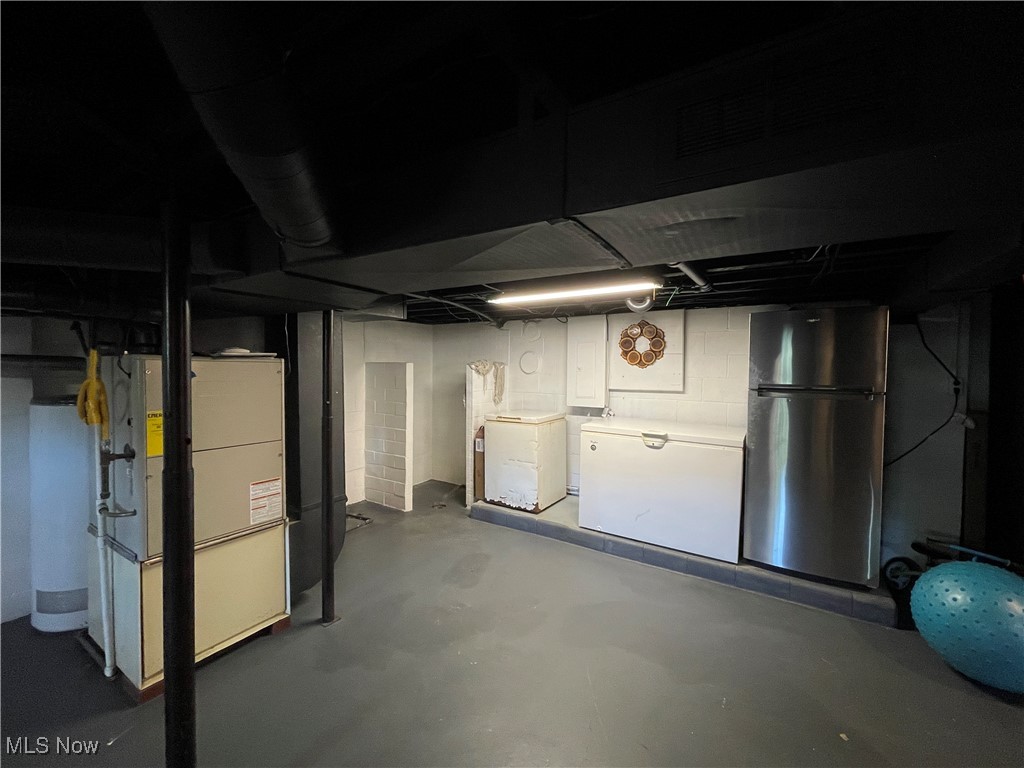 2175 Wainwright Road New Philadelphia, OH 44663 - Photo 21 of 27 Basement featuring washer and clothes dryer, stainless steel refrigerator, and white fridge