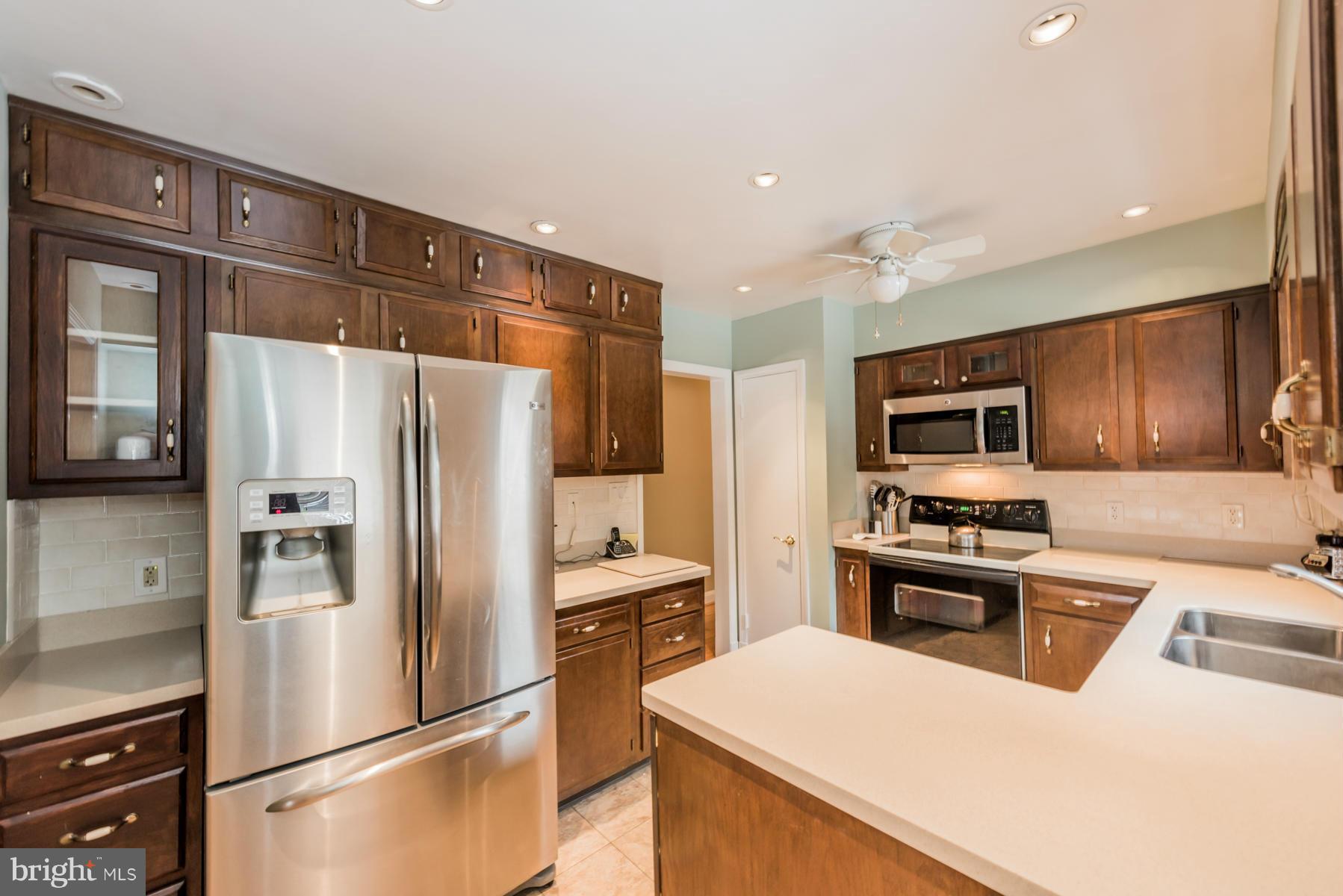 1210 Belfast Road Sparks, MD 21152 - Photo 12 of 29 a kitchen with stainless steel appliances a refrigerator stove microwave and sink