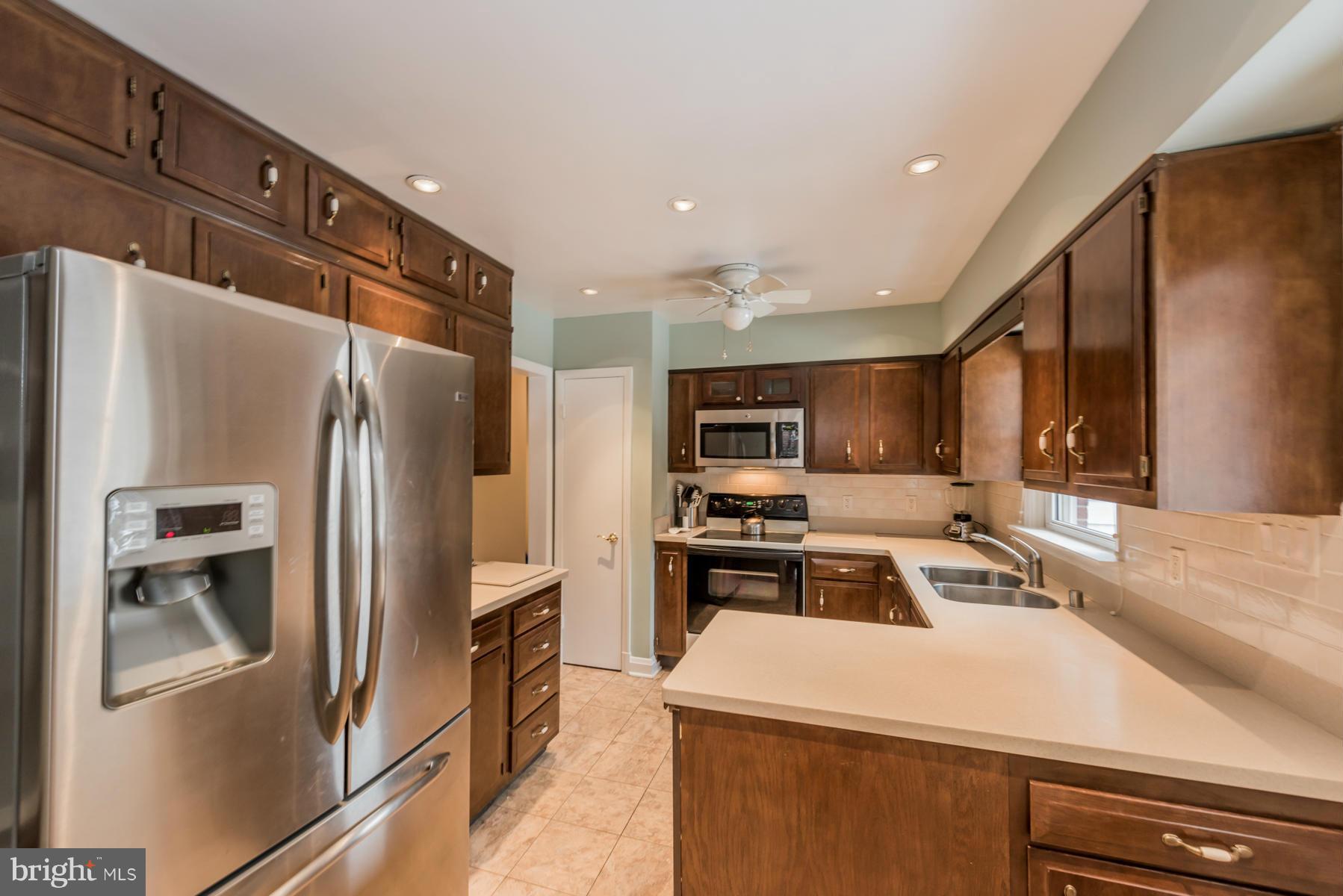 1210 Belfast Road Sparks, MD 21152 - Photo 14 of 29 a kitchen with stainless steel appliances a refrigerator stove microwave and sink