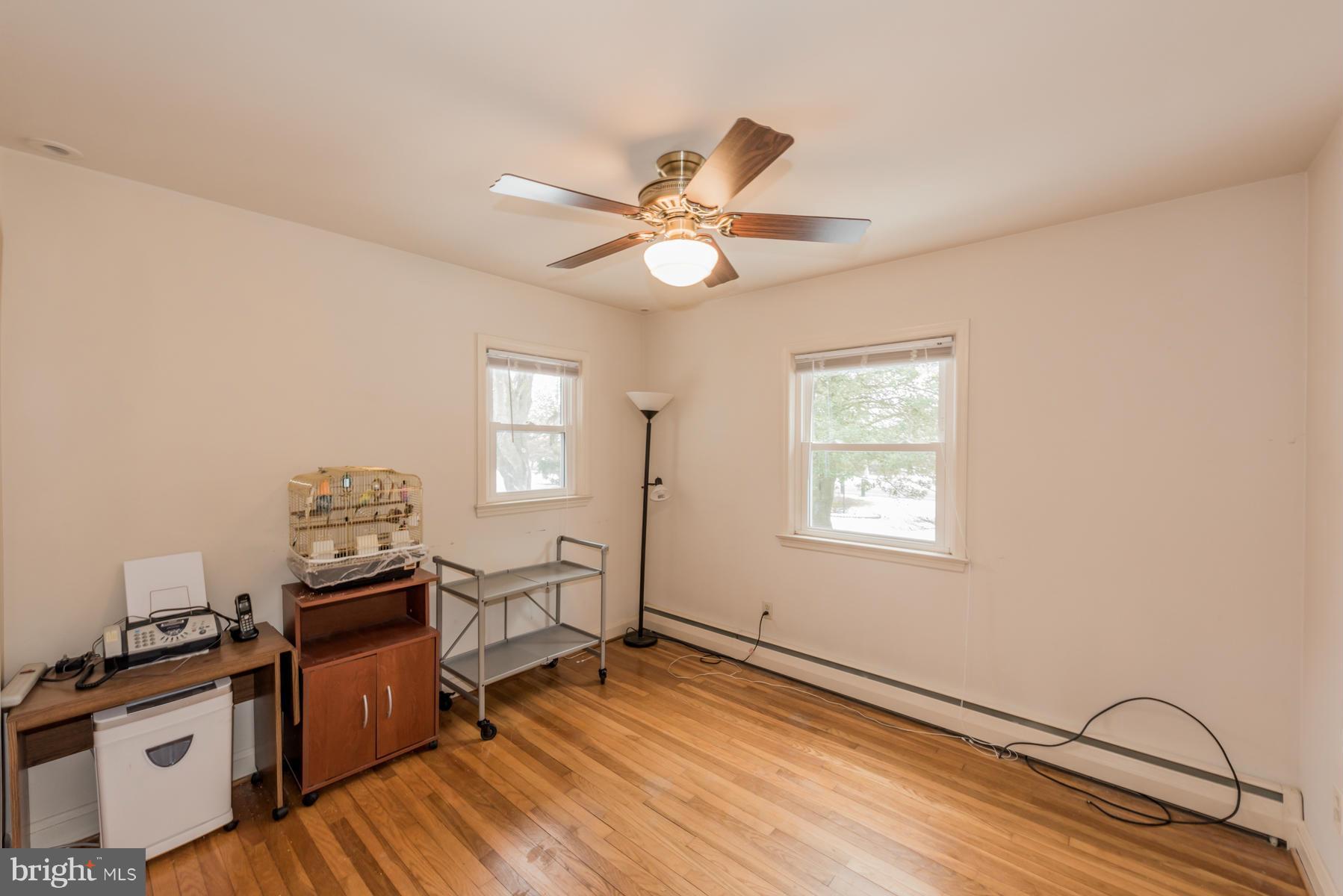 1210 Belfast Road Sparks, MD 21152 - Photo 19 of 29 a workspace with wooden floor a chandelier fan and windows