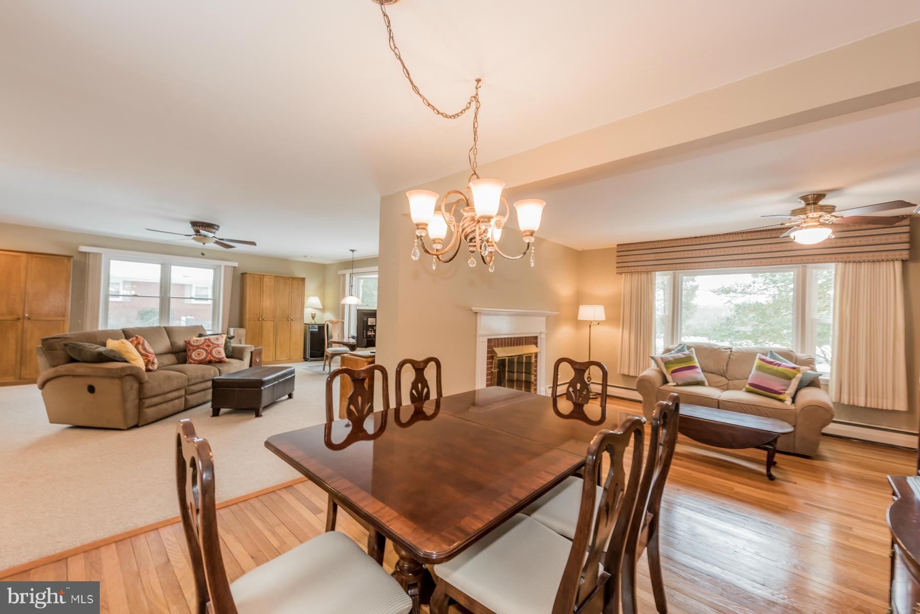 1210 Belfast Road Sparks, MD 21152 - Photo 6 of 29 a view of a dining room with furniture a chandelier and wooden floor