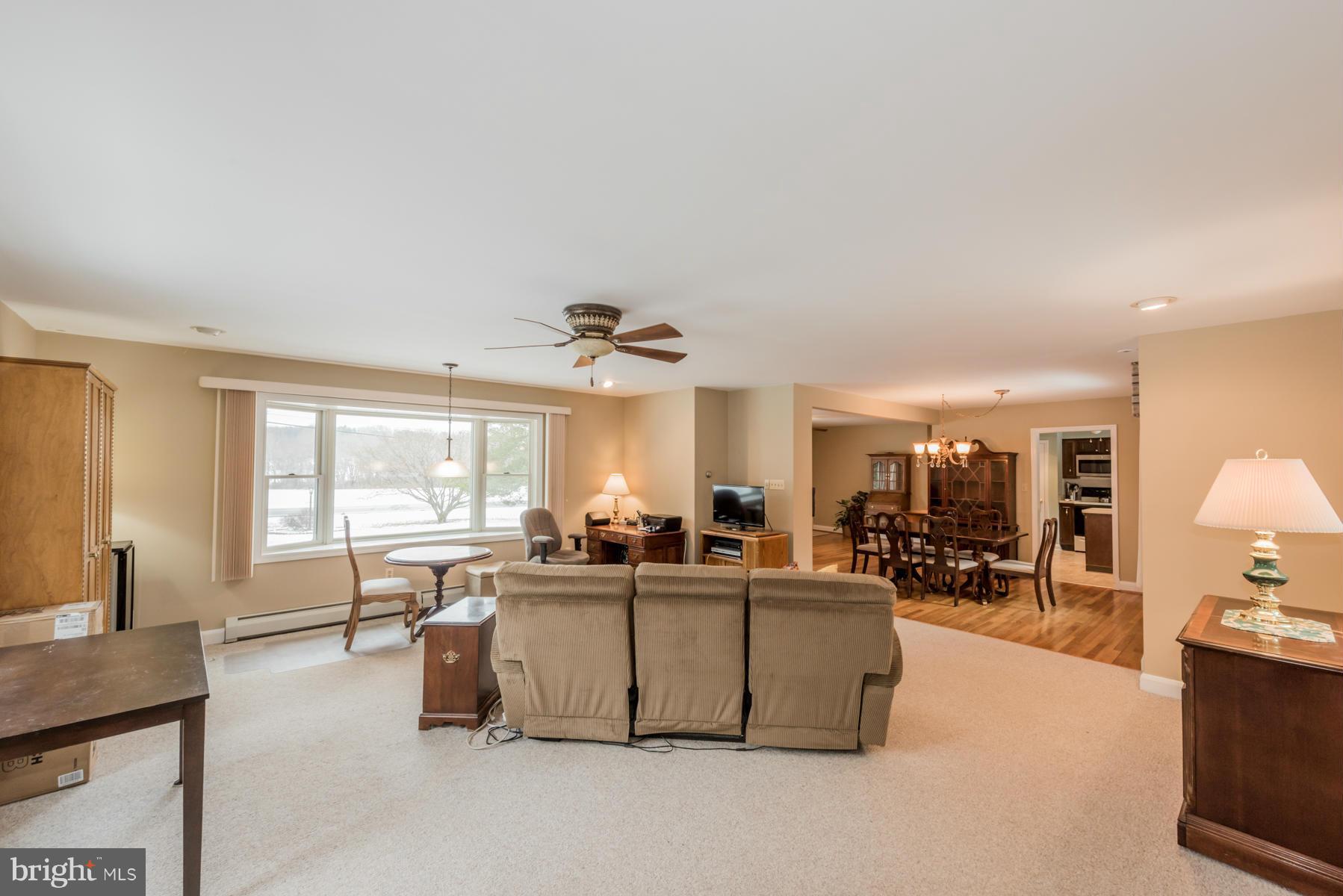 1210 Belfast Road Sparks, MD 21152 - Photo 9 of 29 a living room with furniture a dining table and chairs
