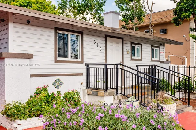 a view of a house with a flower garden