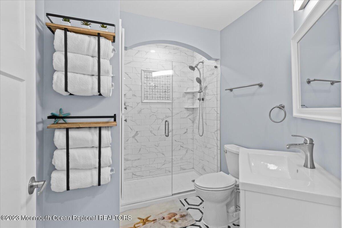 15 Dune Terrace, Unit 15B Seaside Heights, NJ 08751 - Photo 18 of 22 a bathroom with a sink toilet and shower