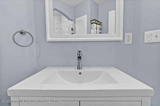 a bathroom with a sink and mirror