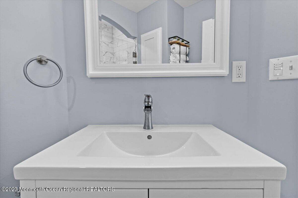 15 Dune Terrace, Unit 15B Seaside Heights, NJ 08751 - Photo 20 of 22 a bathroom with a sink and mirror