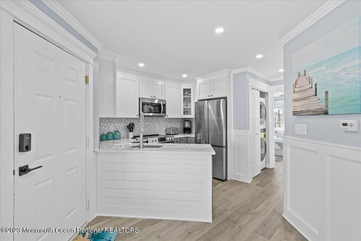 15 Dune Terrace, Unit 15B Seaside Heights, NJ 08751 - Photo 8 of 22 a kitchen with refrigerator and cabinets