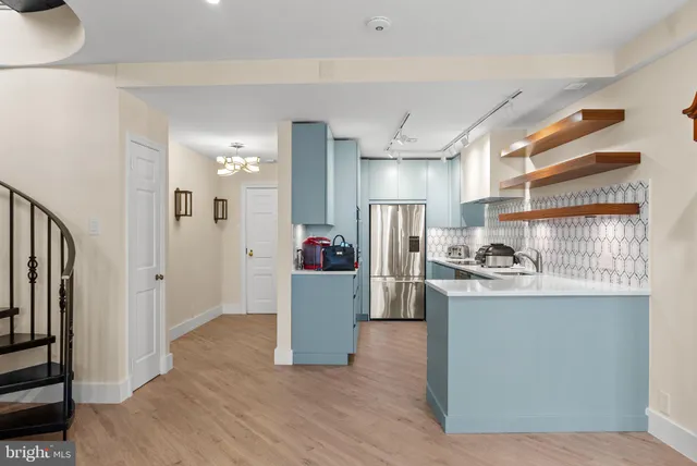 a kitchen with cabinets and stainless steel appliances