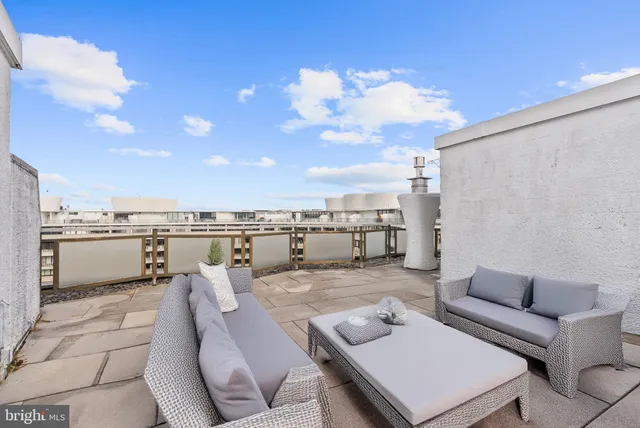 a terrace with outdoor seating and city view
