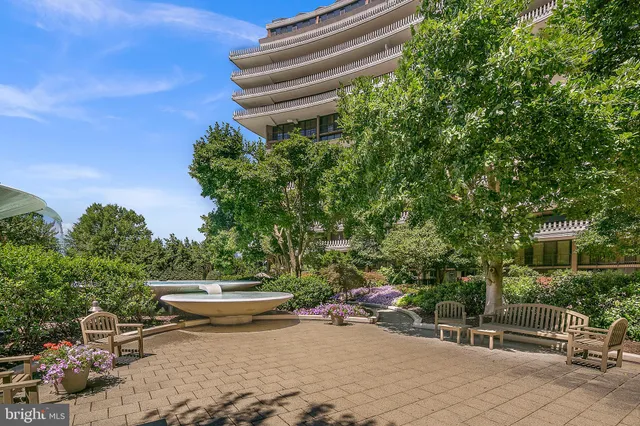 a view of a swimming pool with a yard and sitting area
