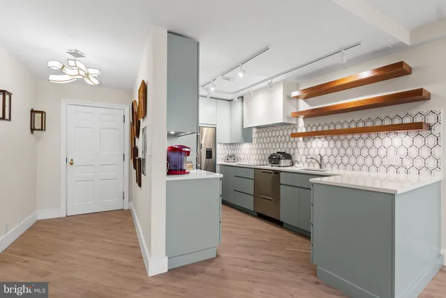 a room that has a lot of cabinets and wooden floor