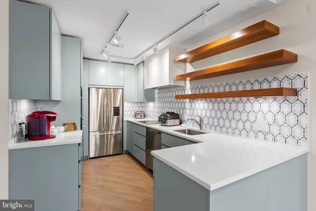 a kitchen with stainless steel appliances a refrigerator and a stove