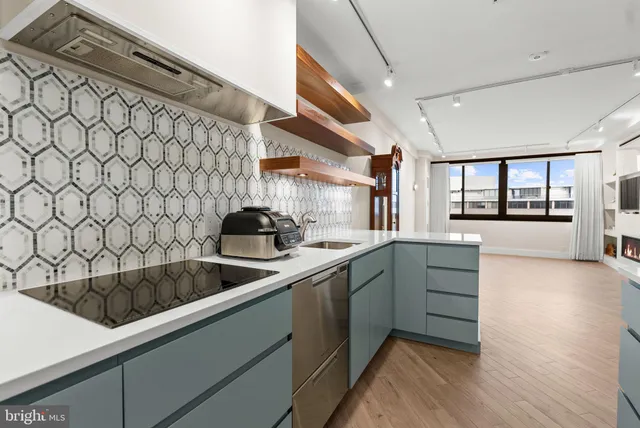 a kitchen with a sink and large window