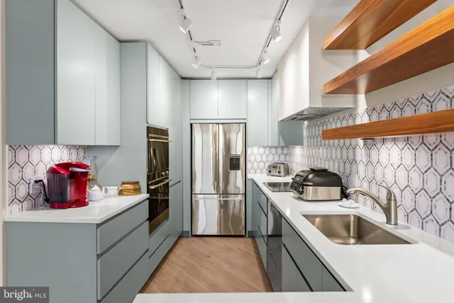 a kitchen filled a sink a refrigerator and window