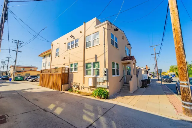 a living room with furniture a fireplace and a potted plant