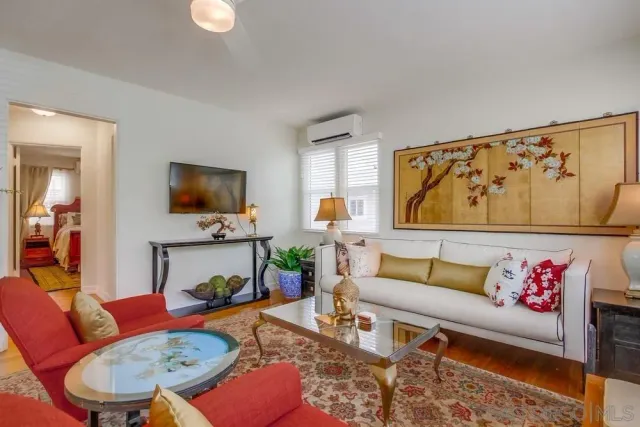 a living room with furniture and a flat screen tv