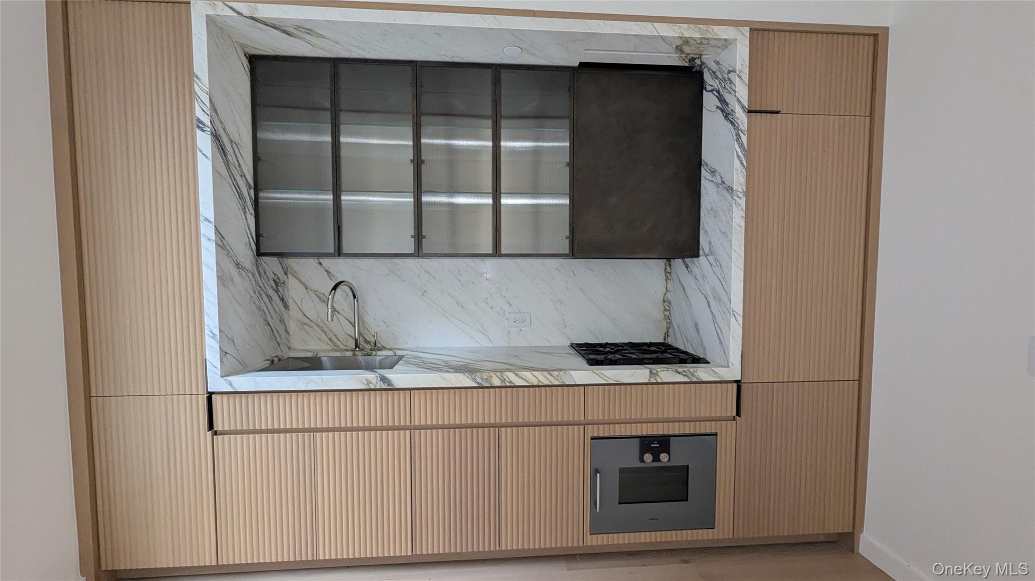 135 East 47th Street, Unit 21A Manhattan, NY 10017 - Photo 1 of 21 a kitchen with a cabinets and a stove