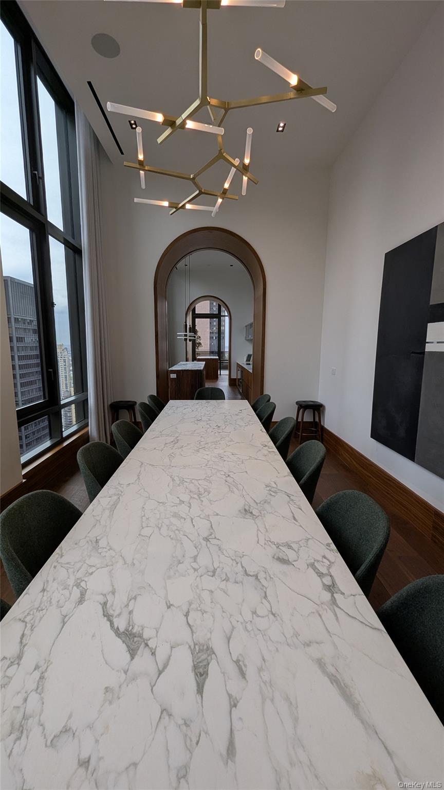 135 East 47th Street, Unit 21A Manhattan, NY 10017 - Photo 12 of 21 a large bed sitting in a bedroom next to a window