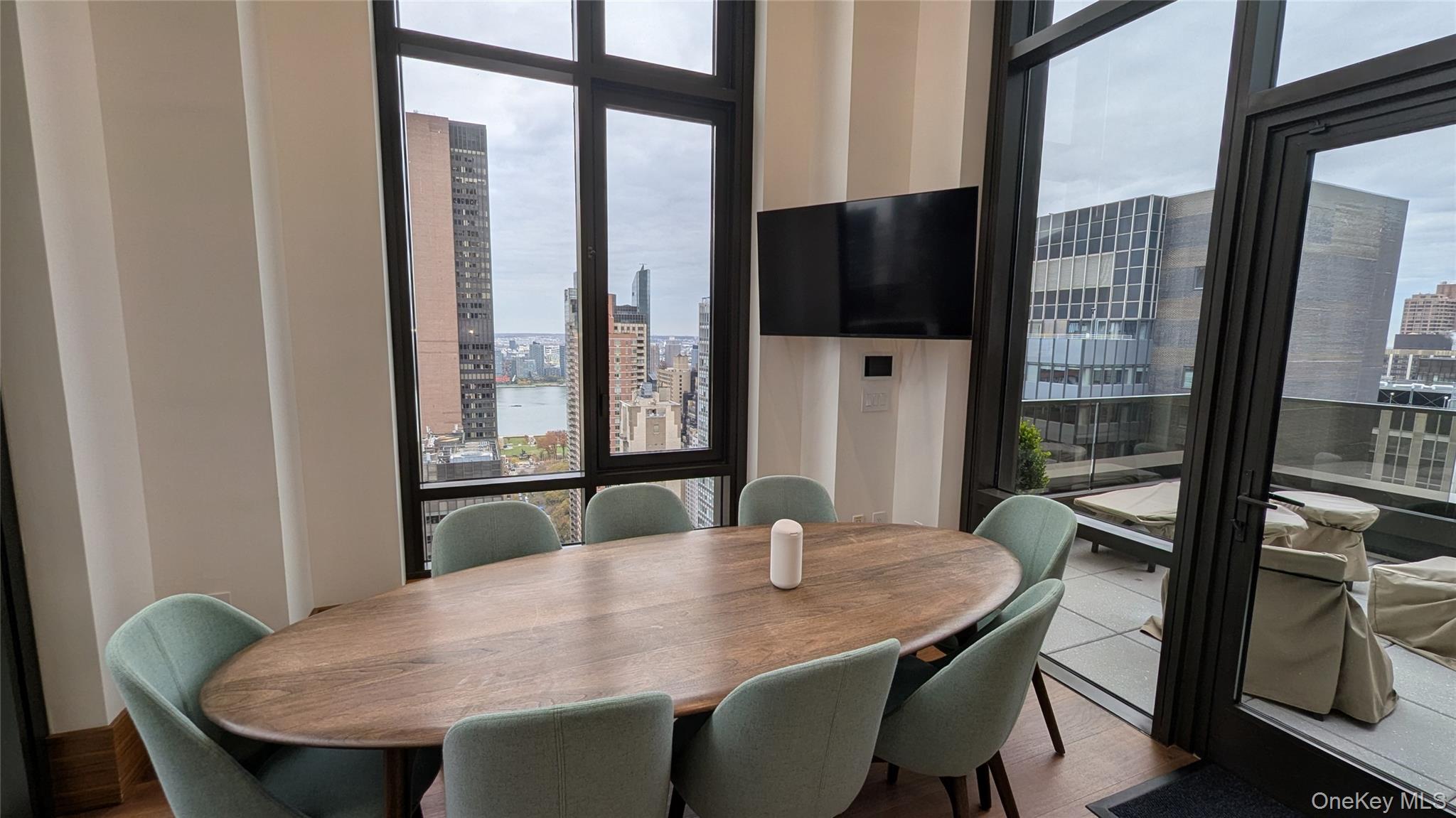 135 East 47th Street, Unit 21A Manhattan, NY 10017 - Photo 14 of 21 a view of a dining room with furniture