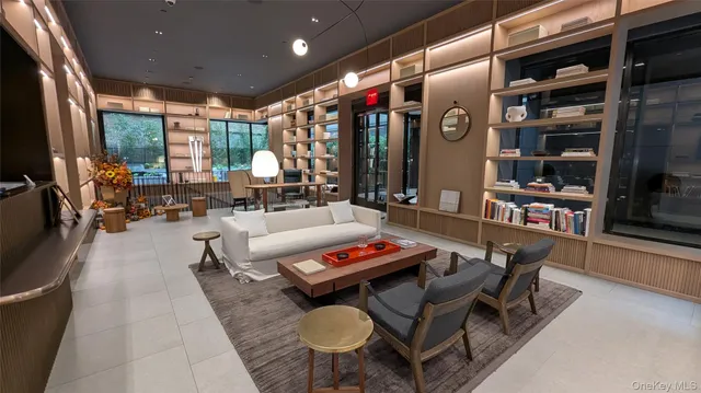 a living room with furniture and a floor to ceiling window