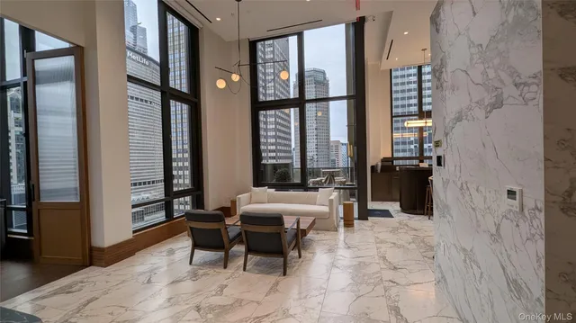 a bedroom with furniture and large windows