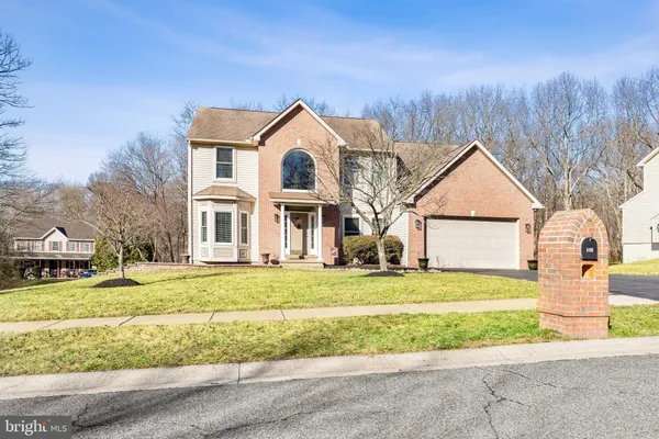a view of a house with a yard and fence