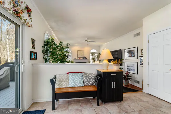 a room with table chairs and window