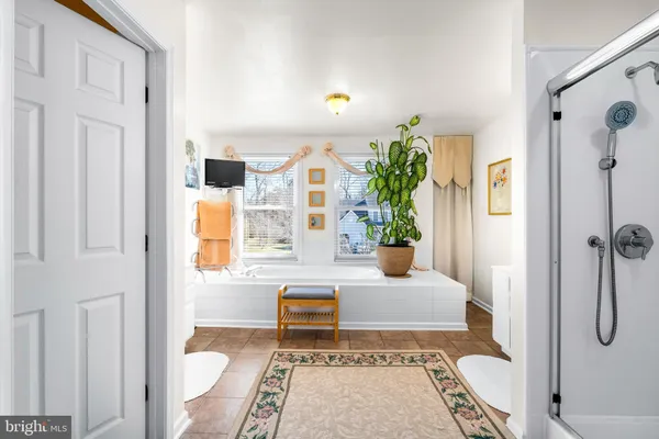 a bathroom with a bathtub and shower