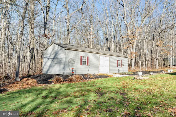 a front view of house with yard and trees